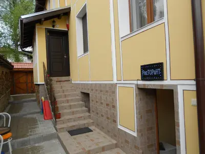a building with a staircase leading up to a door at Guest House Tsenovi in Koprivshtitsa