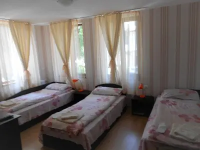 three beds in a room with windows and curtains at Guest House Tsenovi in Koprivshtitsa