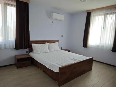 a bedroom with a bed and two windows at Къща за гости Савана, Пловдив,Plovdiv, летище Пловдив, Plovdiv Airport,Ягодово in Yagodovo