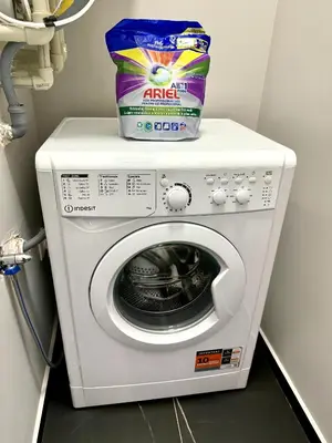 a washer and dryer with a bag on top of it at AveNew Luxury Apartment 3 in Sofia