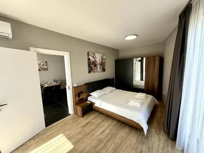 a bedroom with a bed and a sink and a mirror at AveNew Luxury Apartment 3 in Sofia