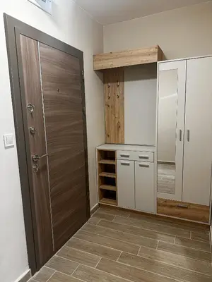a kitchen with a closet and a wooden door at Bibi Central Apartment Plovdiv in Plovdiv