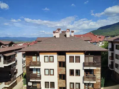 an apartment building with a roof with balconies at ТОП Локация и УЮТ in Bansko