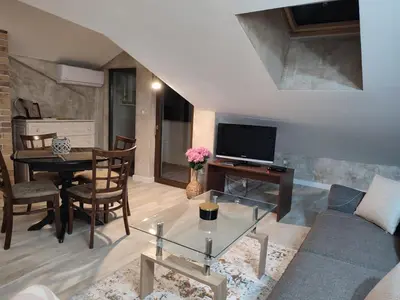a living room with a couch and a table at ТОП Локация и УЮТ in Bansko