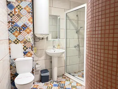 a bathroom with a toilet and a sink and a shower at Center Apartments The Quiet Luxury 1 in Plovdiv