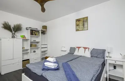 a white bedroom with a bed and a desk at Cozy 1BD Flat Close to the City Center by Flat Mаnager in Sofia