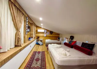 a room with two beds and a large window at Къща за гости Casa La Tinozza in Hisarya
