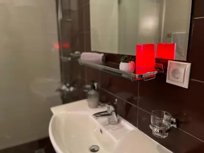 a bathroom with a sink and a mirror at 2BR Apartment Near Gondola by SI Stay in Bansko