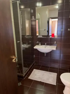 a bathroom with a sink and a shower and a toilet at 2BR Apartment Near Gondola by SI Stay in Bansko