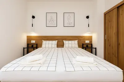 a bedroom with a large white bed with two pillows at Cozy and comfortable northern apartment, Kapana district, Plovdiv, Center in Plovdiv