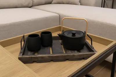 a tray with two pots on a coffee table next to a bed at Cozy and comfortable northern apartment, Kapana district, Plovdiv, Center in Plovdiv