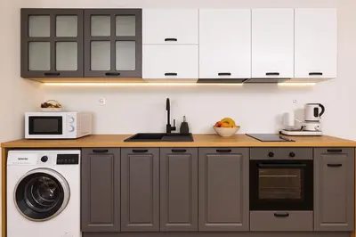 a kitchen with white cabinets and a washer and dryer at Cozy and comfortable southern apartment, Kapana district, Plovdiv, Center in Plovdiv