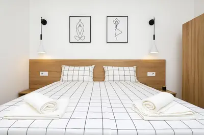 a bedroom with a white bed with two white pillows at Cozy and comfortable southern apartment, Kapana district, Plovdiv, Center in Plovdiv