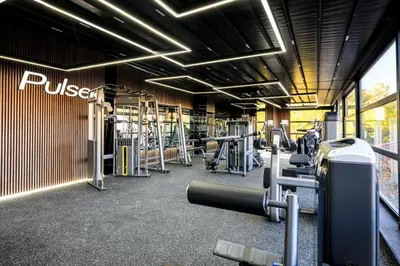a gym with rows of treadmills and machines at Hotel Royal Plovdiv in Plovdiv