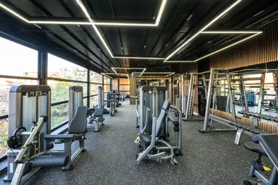 a gym with a row of treadms and machines at Hotel Royal Plovdiv in Plovdiv