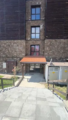 a brick building with a patio with an orange roof at Luxury flat F218 in Bansko