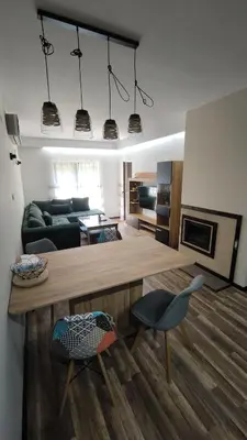 a living room with a couch and a table and chairs at Luxury flat F218 in Bansko