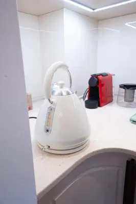 a white tea kettle sitting on top of a counter at Spacious 3-BR Central Retreat in Sofia