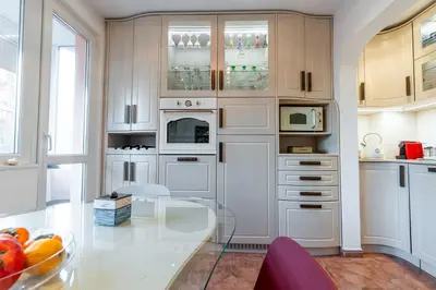a kitchen with white cabinets and a glass table at Spacious 3-BR Central Retreat in Sofia
