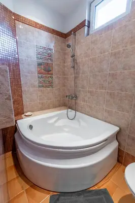a bathroom with a white tub and a toilet at Spacious 3-BR Central Retreat in Sofia