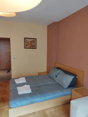 a bedroom with a bed with two towels on it at The Cathedral in Sofia