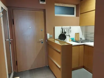 a small kitchen with a door and a sink at The Cathedral in Sofia