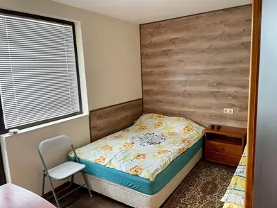 a small bedroom with a bed and a chair at St Georgi in Pamporovo