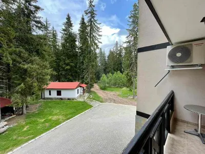 a balcony with a view of a house at St Georgi in Pamporovo