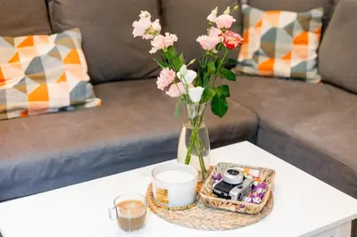 a vase with flowers and a basket on a table at Escape in photos in top centre apartment in Sofia