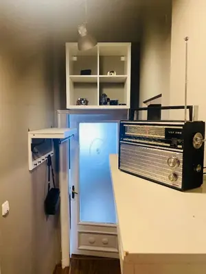 a kitchen with a counter with a refrigerator and a microwave at Escape in photos in top centre apartment in Sofia