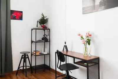 a room with a desk and a table with two stools at Escape in photos in top centre apartment in Sofia