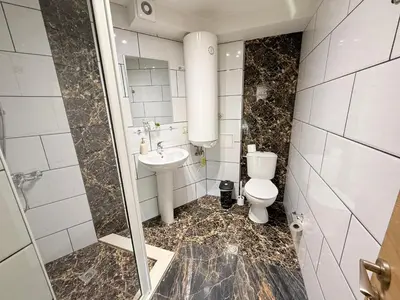 a bathroom with a toilet and a sink at Central 2 Bedroom Apartments The Quiet Luxury 3 in Plovdiv