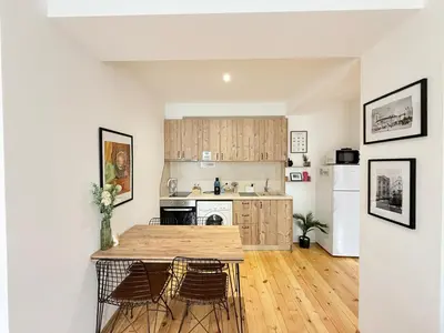 a kitchen with a wooden table and chairs at Central 2 Bedroom Apartments The Quiet Luxury 3 in Plovdiv