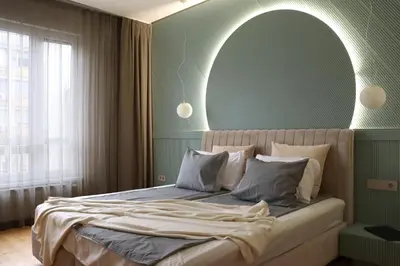 a bedroom with a large bed with a green wall at NEW Glamours Central Suite with Elevator in Sofia