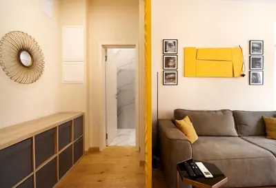 a living room with a couch and a mirror at NEW Glamours Central Suite with Elevator in Sofia