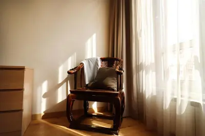 a chair sitting in a room next to a window at NEW Glamours Central Suite with Elevator in Sofia