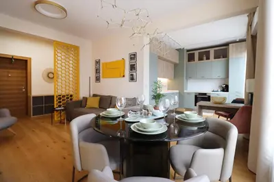 a dining room and living room with a table and chairs at NEW Glamours Central Suite with Elevator in Sofia