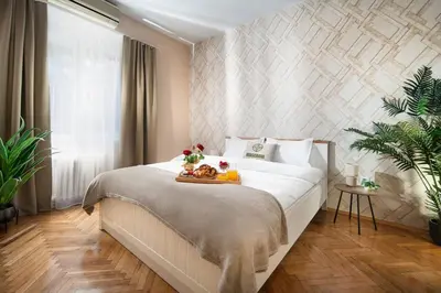 a bedroom with a bed with a tray of food on it at Central And Spacious Home in Sofia