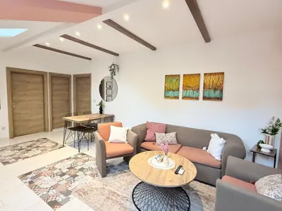 a living room with a couch and a table at Center Apartments The Quiet Luxury 5 in Plovdiv