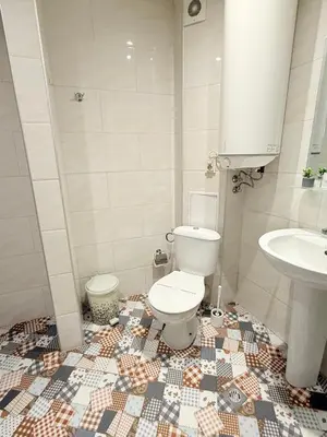 a bathroom with a toilet and a sink at Center Apartments The Quiet Luxury 5 in Plovdiv