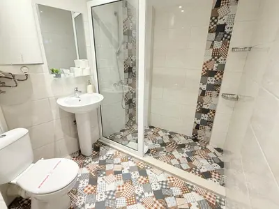 a bathroom with a shower and a toilet and a sink at Center Apartments The Quiet Luxury 5 in Plovdiv