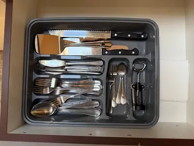 a drawer filled with utensils in a box at Center Apartments The Quiet Luxury 6 in Plovdiv