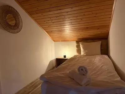 a bed with a pair of towels on it at Center Apartments The Quiet Luxury 6 in Plovdiv