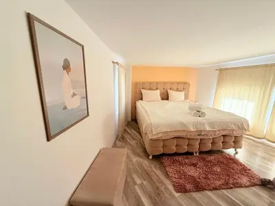 a bedroom with a bed and a picture on the wall at Center Apartments The Quiet Luxury 6 in Plovdiv