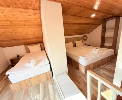 two beds in a room with wooden ceilings at Center Apartments The Quiet Luxury 6 in Plovdiv