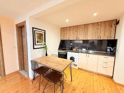 a kitchen with a table and chairs in a room at Center Apartments The Quiet Luxury 7 in Plovdiv