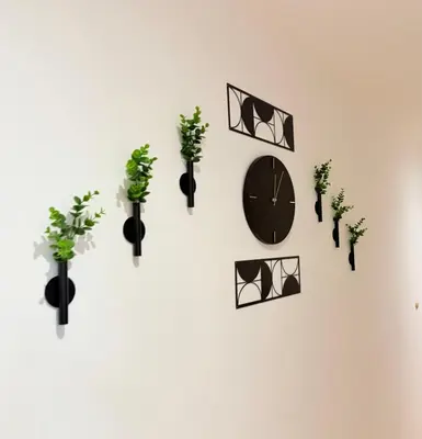 a clock on a white wall with potted plants at Center Apartments The Quiet Luxury 7 in Plovdiv