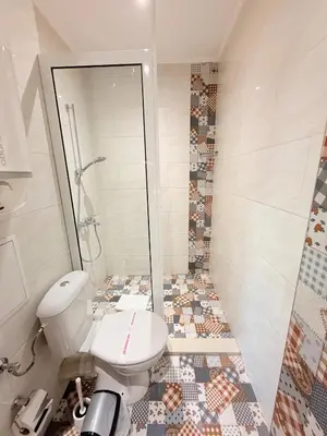 a bathroom with a white toilet and a shower at Central 2 Bedroom Apartments The Quiet Luxury 8 in Plovdiv