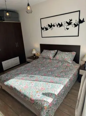 a bedroom with a bed with birds on the wall at Top location unique apartment in Bansko
