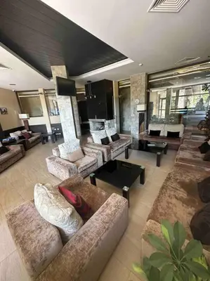 a large living room with couches and a fireplace at Top location unique apartment in Bansko